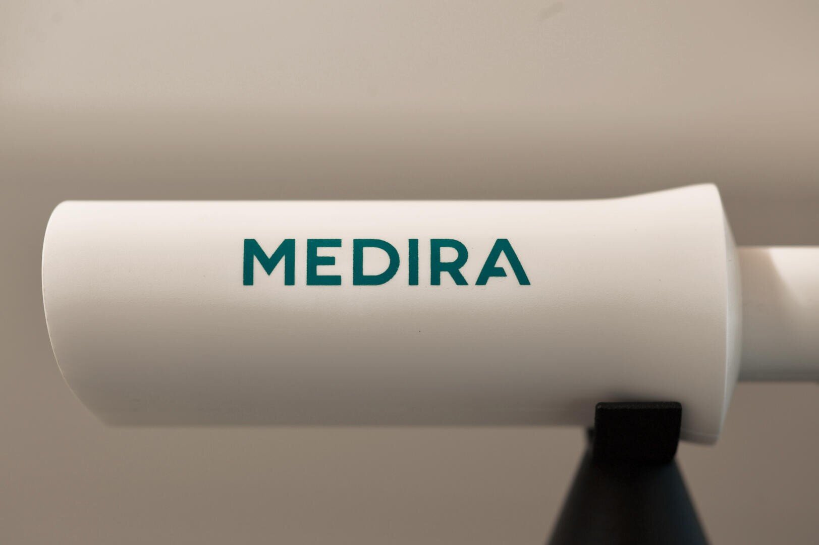 A close-up of a white cylindrical object with the word MEDIRA printed in teal capital letters on its side. The background is out of focus.