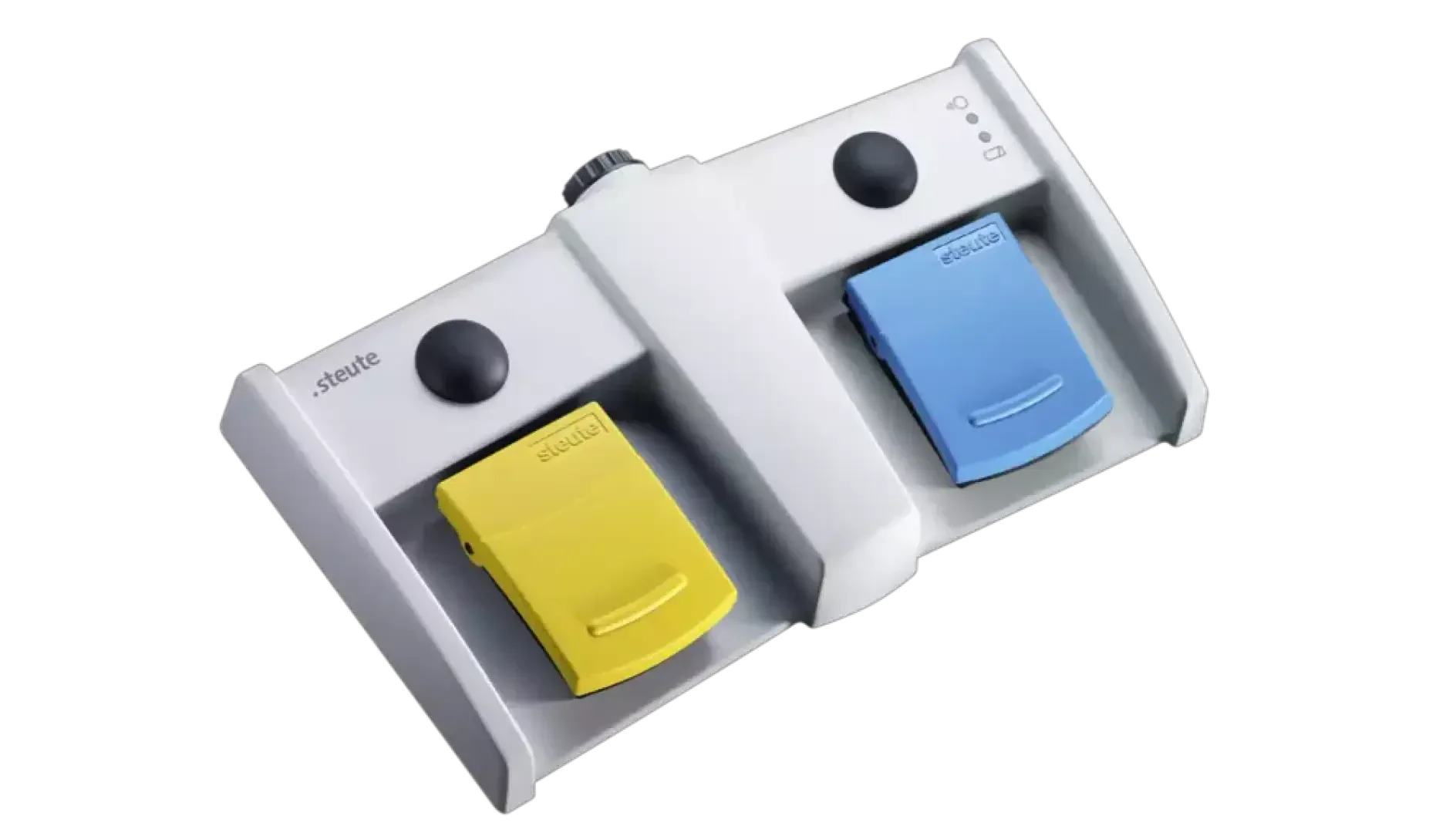 Foot-operated medical pedal device with two pedals – one yellow and one blue – above each of which is a round black button, housed in a white housing, used for hands-free control of medical devices.