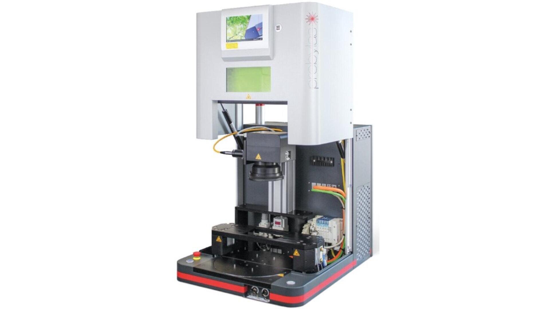 A laboratory hardness tester machine with a digital display and various control panels, featuring an exposed testing area and precision components used for material analysis.