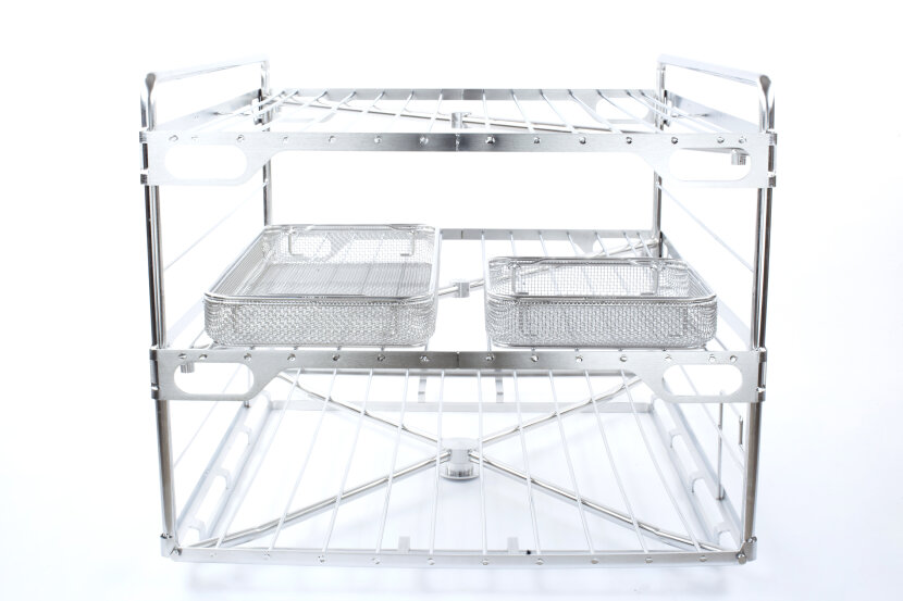 A two-tier stainless steel kitchen rack with a wire shelf on top and two mesh baskets on the middle shelf, designed for organized storage. The rack has an open, minimalist structure.