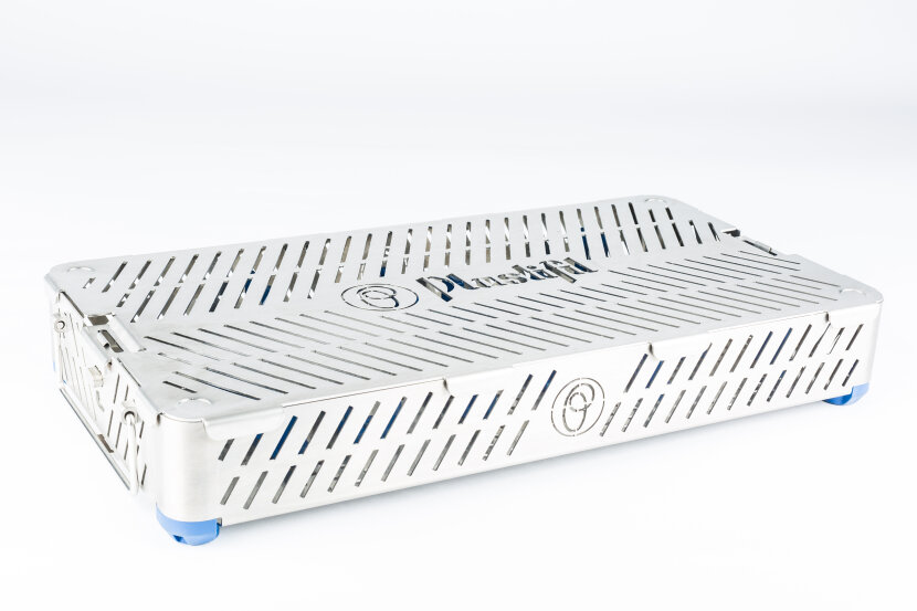 A rectangular stainless steel medical sterilization container with slotted ventilation holes, blue corner pads, and a Pluslok logo on the lid, placed on a white background.