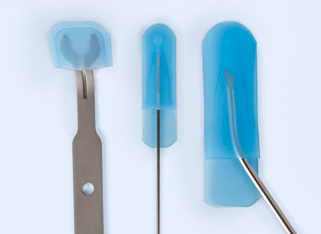 Three metal dental instruments, each partially covered with fitted blue protective covers, are displayed vertically against a light background. The tools vary in shape and size.